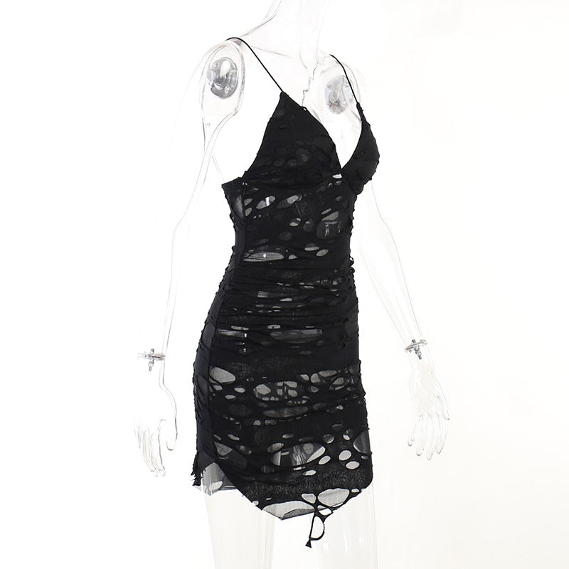 Black distressed mesh mini dress displayed in profile on a mannequin.