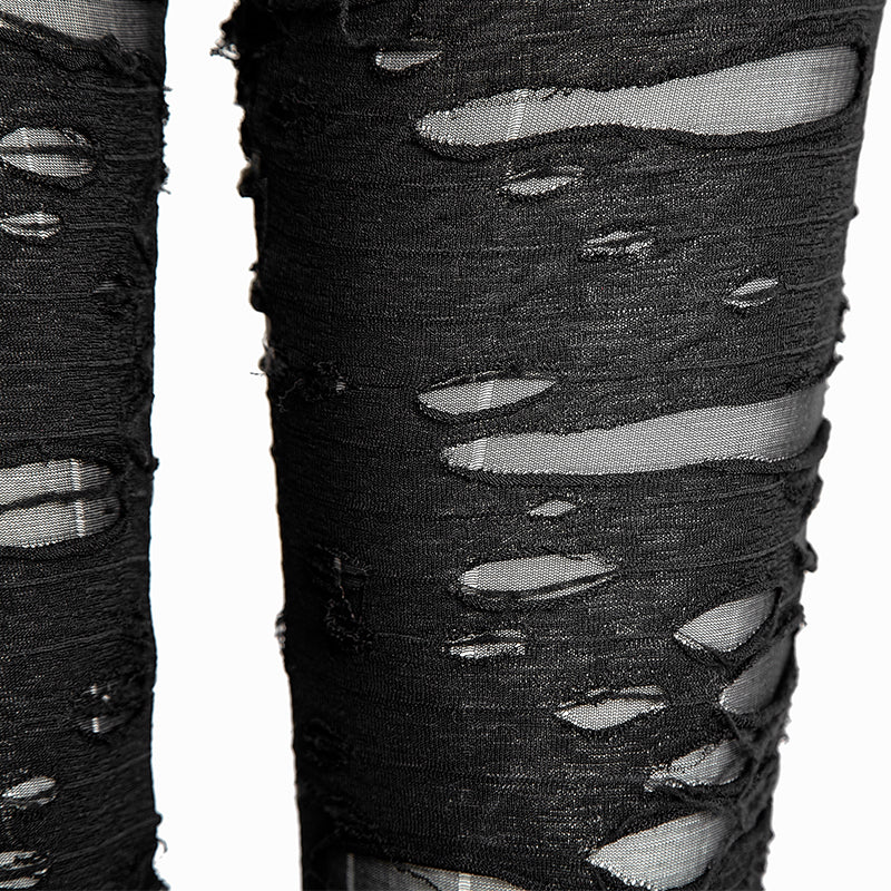 Close-up of black distressed pants showing frayed horizontal strips over fine, semi-sheer mesh and the texture around the torn edges.