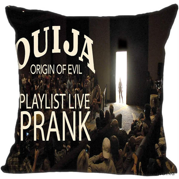 Black square Ouija-themed pillow cover printed with large pale lettering and a dark seated crowd facing a bright doorway.