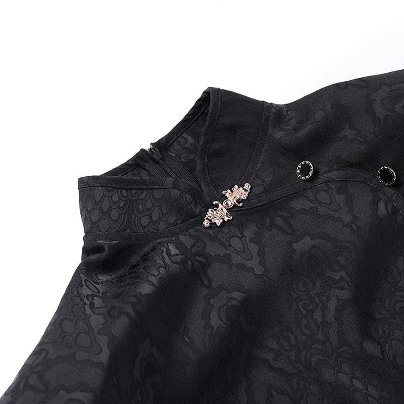 Close-up of the black cheongsam collar, showing the decorative clasp, round button accents and tonal dragon pattern.