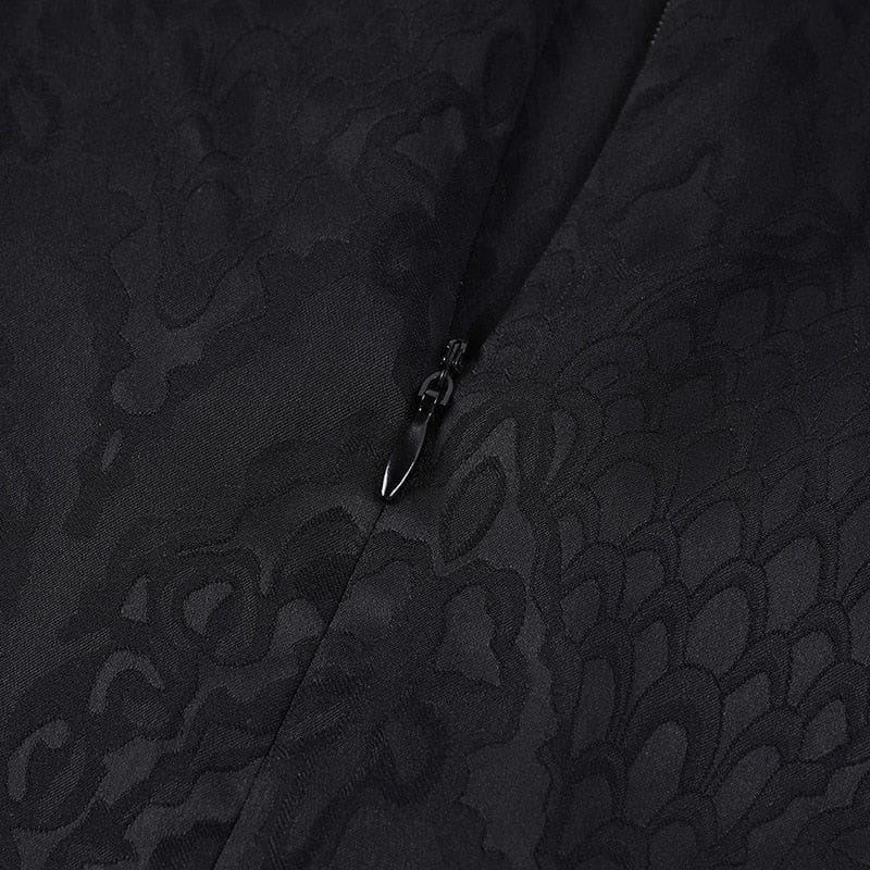 Close-up of the black cheongsam's concealed zipper set into a seam amid the tonal patterned fabric.