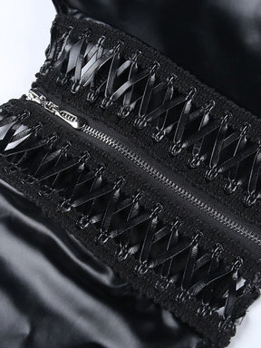 Angled macro view of the two ribbon-laced front panels beside the metal zipper, with open spaces between the crossing black ribbons.