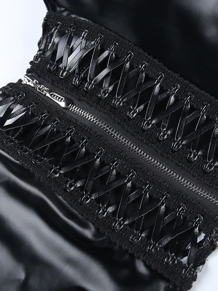 Angled macro view of the two ribbon-laced front panels beside the metal zipper, with open spaces between the crossing black ribbons.
