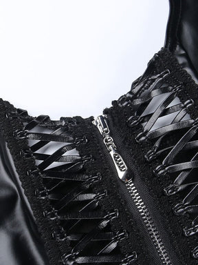 Detail of the front zipper and black crisscross ribbons, showing textured trim framing two open panels on the glossy crop top.