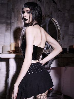 Rear view of the black halter crop top, showing the neck strap and open upper back above the short glossy body and studded skirt.