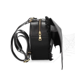 Black bat wing backpack with curved wing stitching, lace trim, a zip closure, and buckle shoulder straps.