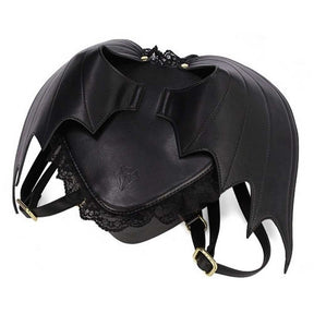Black bat wing backpack with curved wing stitching, lace trim, a zip closure, and buckle shoulder straps.