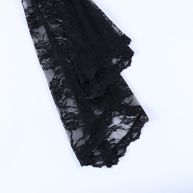 Close view of the overlay's black bell sleeve hem, showing the layered folds and scalloped ruffled edging.