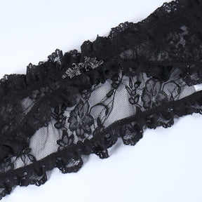 Ornate dark silver-tone clasp centered on the black floral lace overlay, bordered by small ruffles.