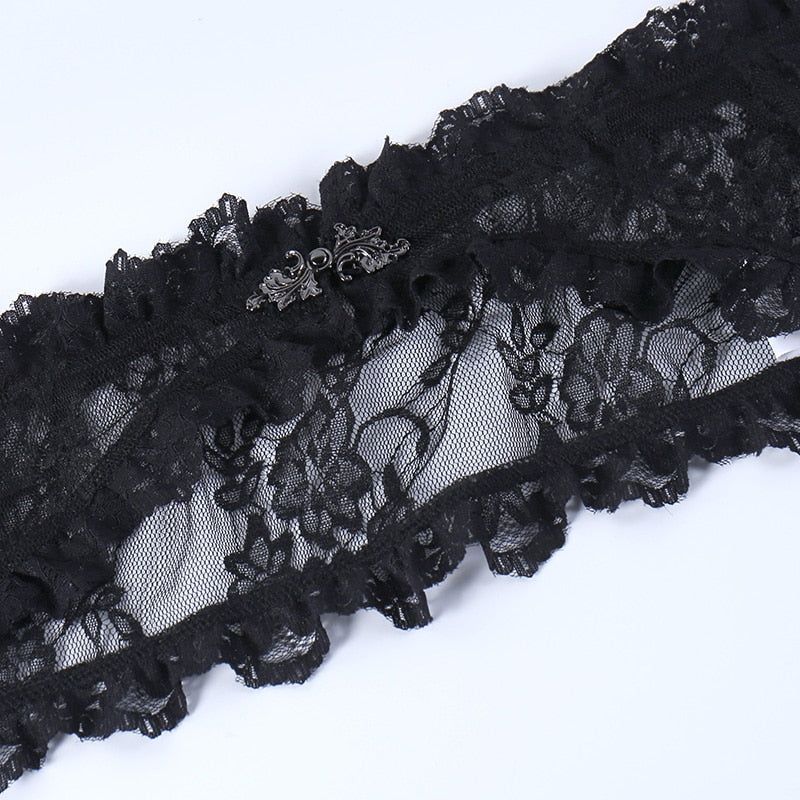 Ornate dark silver-tone clasp centered on the black floral lace overlay, bordered by small ruffles.