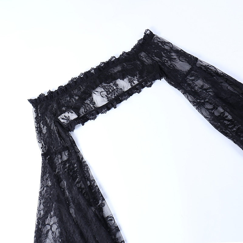 Black lace overlay laid diagonally on white, showing the front clasp between the long sleeves.