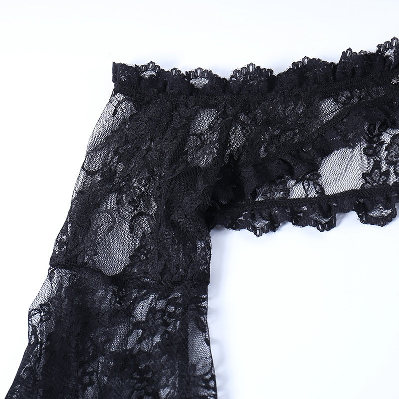 Detail of the floral lace shoulder band and sleeve seam on the black gothic overlay.