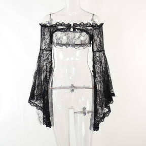 Front view of the black lace overlay on a clear mannequin, showing the open front beneath its clasp and asymmetrical bell-sleeve edges.