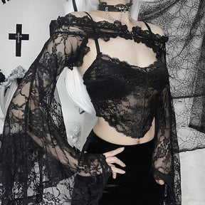 Black gothic lace overlay photographed at an angle, highlighting the flared sleeve beside a separate cami and dark shorts.