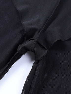 Close view of the inner brief lining at the crotch of the black mesh bell bottoms, with the opaque and sheer layers shown together.