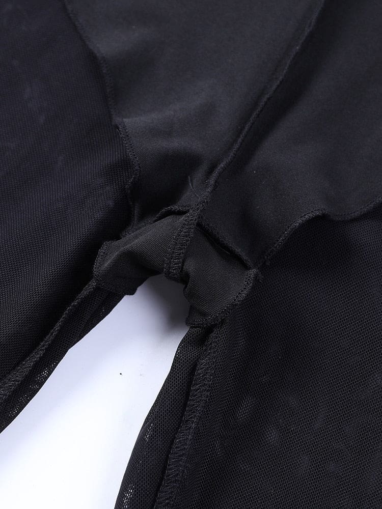 Close view of the inner brief lining at the crotch of the black mesh bell bottoms, with the opaque and sheer layers shown together.