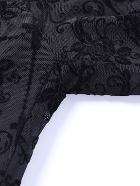 Close view of the upper inner-leg seam on the black patterned mesh bell bottoms, with the dark stitching visible through the sheer fabric.