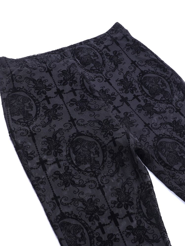 Black bell bottom pants laid flat at the waistband and upper legs. Dark scrollwork overlays the fine mesh around the lined upper section.