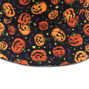 Close-up of the Halloween bucket hat's brim, showing stitched rows through orange jack-o-lanterns, yellow stars and small purple bat shapes.