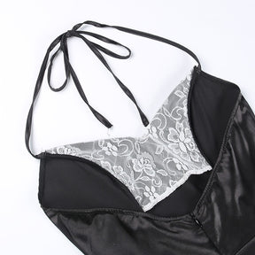 Inside view of the black halter dress neckline with the ties spread above the white lace panels.