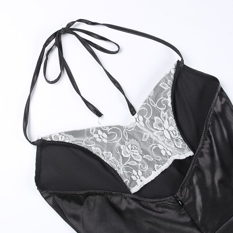 Inside view of the black halter dress neckline with the ties spread above the white lace panels.