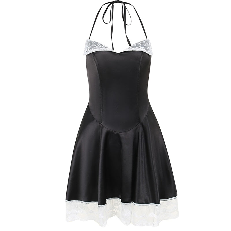 Black halter mini dress isolated on white, with tie-neck straps, white lace lapels and a flared lace-trimmed hem.