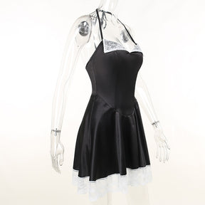 Angled clear-mannequin view of the black satin-finish halter dress with white lace at the neckline and hem.