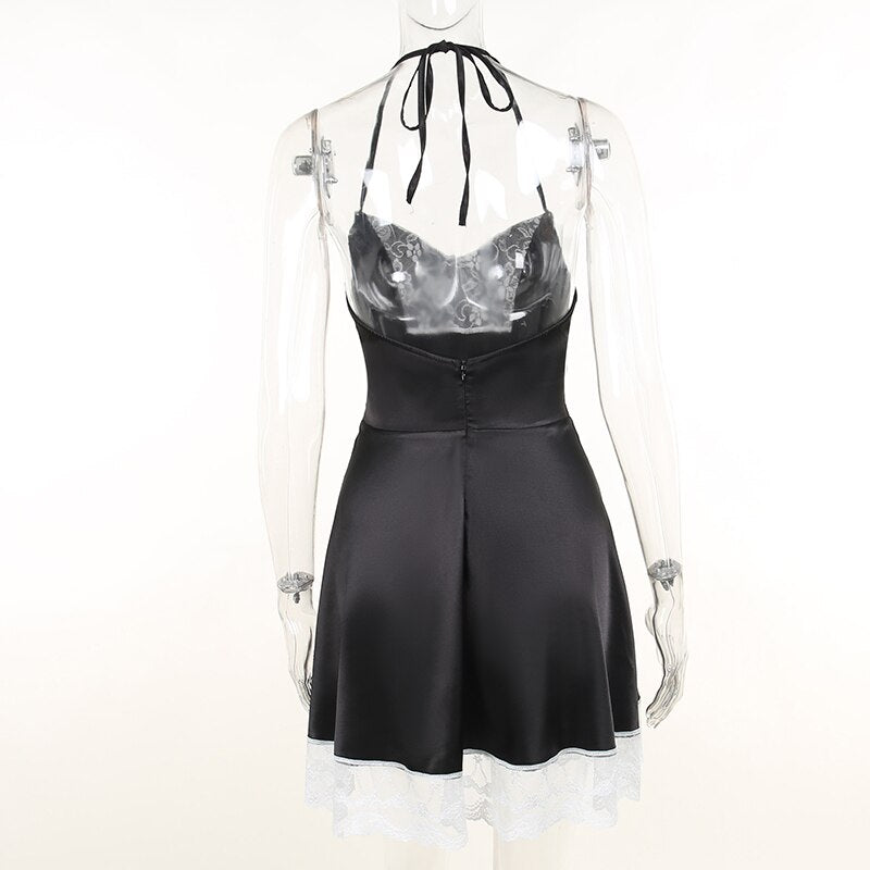 Back of the gothic halter dress on a clear mannequin, showing the neck ties, low back and central zip seam.