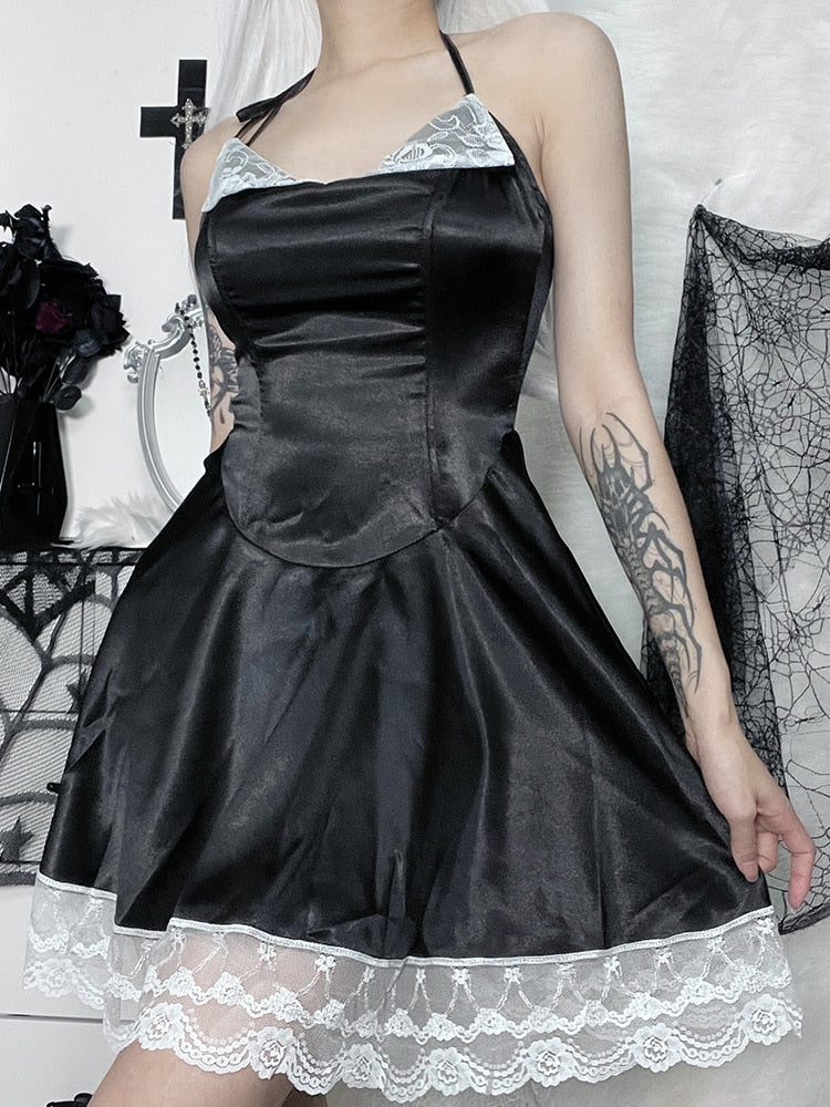 Front outfit view of the black satin-finish halter dress, showing its shaped bodice and broad white lace band around the skirt.