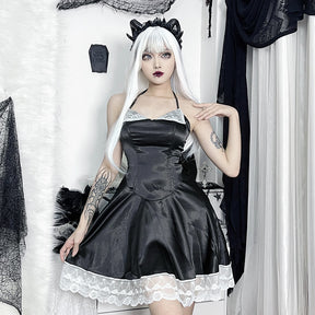 Model in the black and white lace dress with one hand raised near the shoulder, showing the short A-line silhouette.