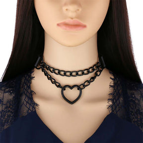Black double-chain heart choker on a mannequin wearing a dark lace neckline, showing how the two chain rows sit at the front of the neck.