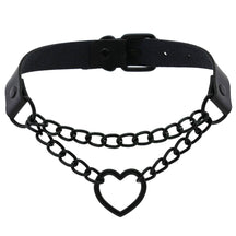 Black faux leather choker with a double-chain front and open heart pendant, arranged to show the band and buckle behind the chains.