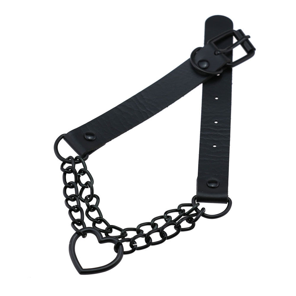 Black double-chain heart choker arranged diagonally, showing the open heart beneath the chains and the faux leather band folded behind it.