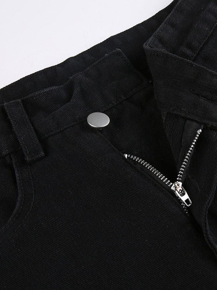 Close-up of the jeans’ asymmetric waistband with a silver-tone button, belt loops and the zip fly partly open.