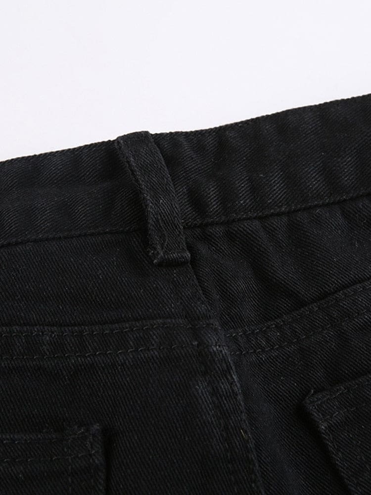 Detail of a belt loop and the stitched black denim waistband above a pocket edge.