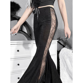 Angled view of the black bell bottoms, highlighting the floral lace panel from upper hip to flared hem.