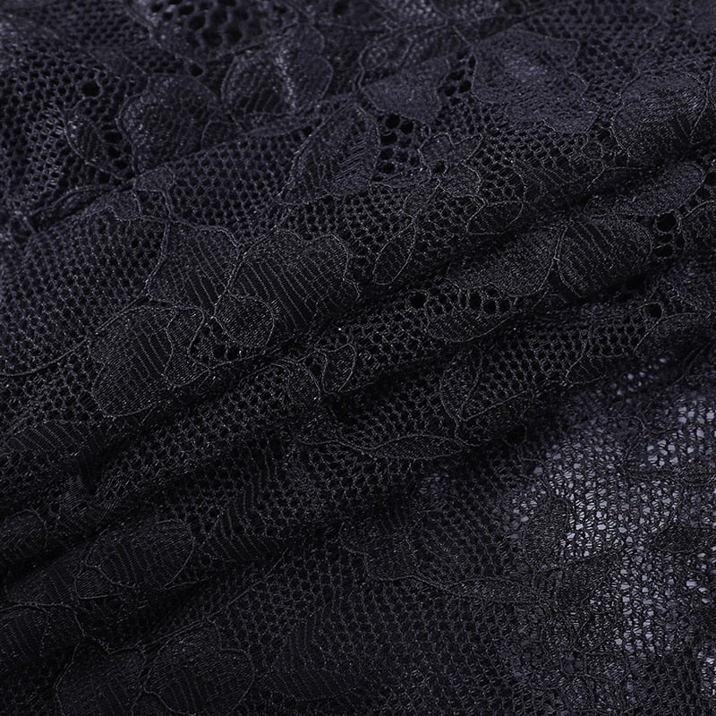 Close-up of floral black lace over fine net on the separate camisole shown for styling. This fabric detail belongs to the camisole, not the velvet bolero.