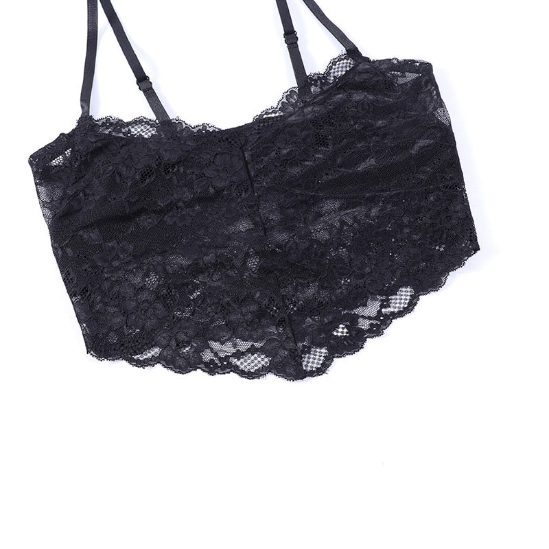 Black floral lace camisole laid on a pale background, showing its straight upper edge, thin straps and scalloped lower edge. The camisole is not included.