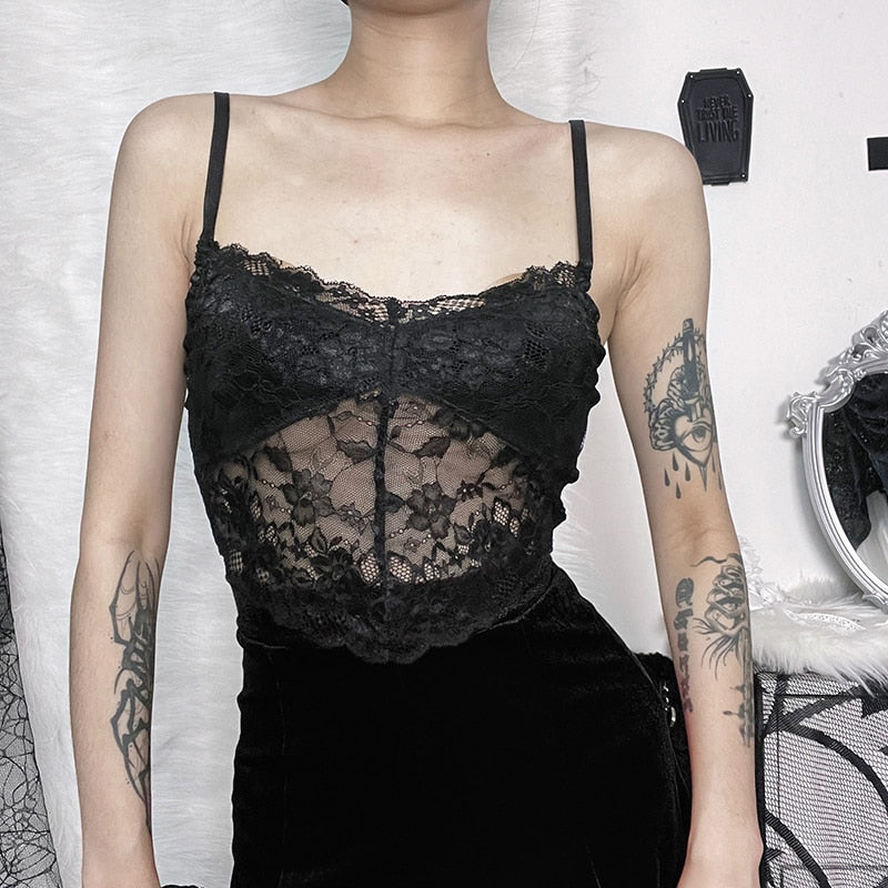 Front outfit view of a separate black lace camisole with thin straps and a scalloped hem, worn with a black skirt. This camisole is not included with the velvet overlay.