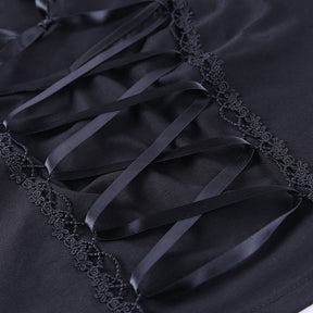 Close-up of crisscross black ribbon over the opaque front panel, bordered by narrow decorative looped trim.
