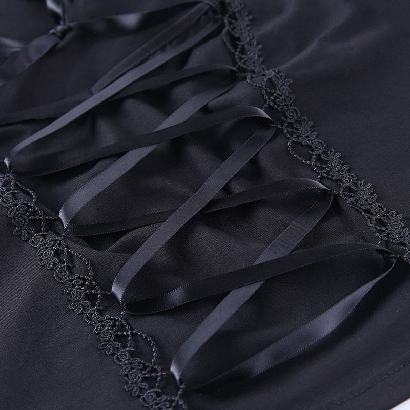 Close-up of crisscross black ribbon over the opaque front panel, bordered by narrow decorative looped trim.