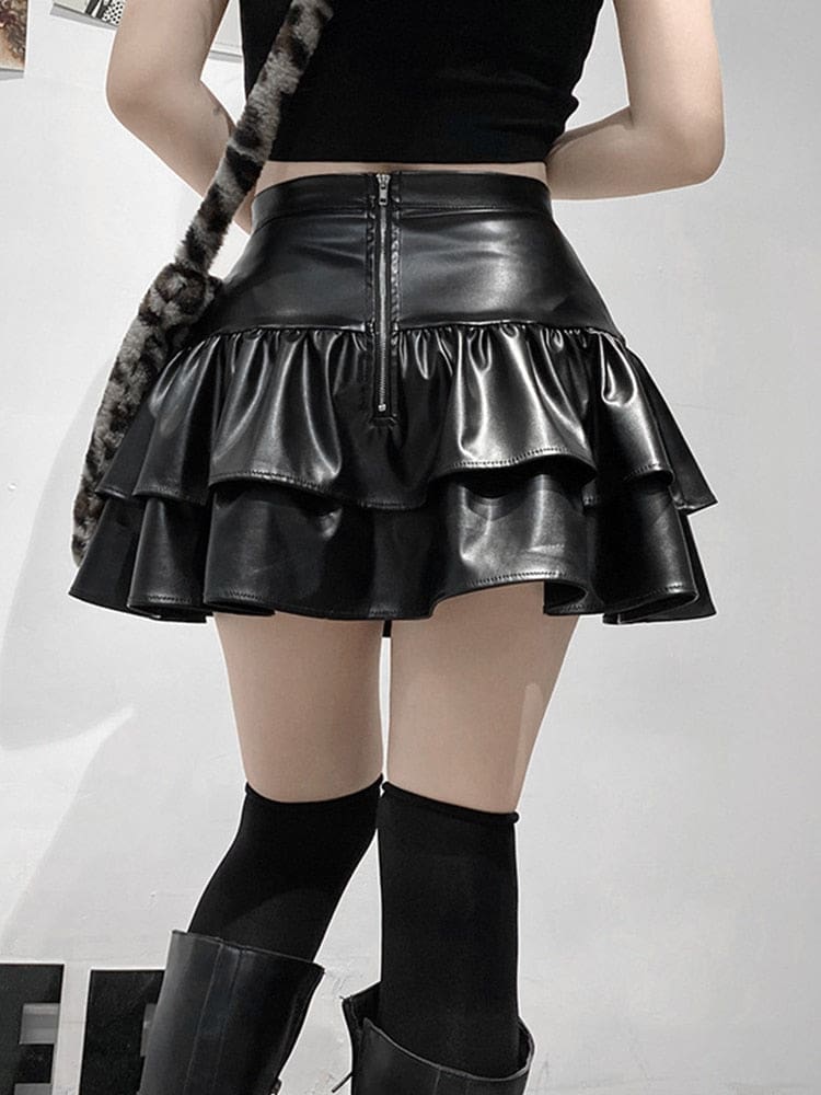 Rear view of the black faux leather ruffle mini skirt on a standing model, showing the centre-back zipper above the two tiers.