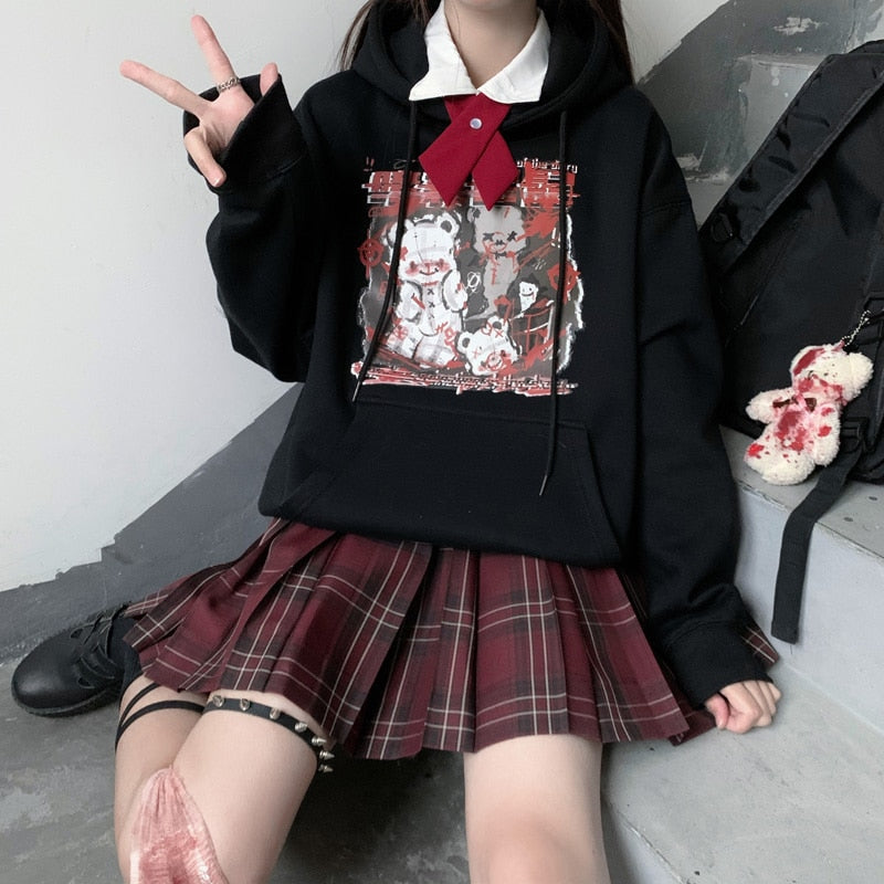 Black Menhera bear graphic hoodie worn in a seated outfit with the front print visible.