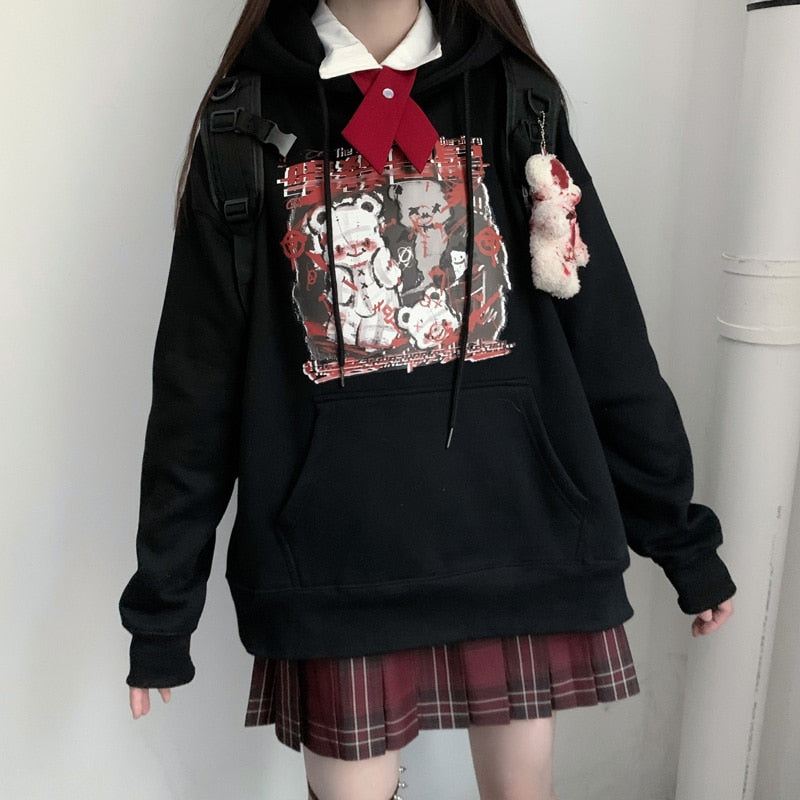 Black Menhera bear graphic hoodie shown in a standing outfit with a separate plaid skirt.