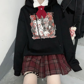 Black Menhera bear graphic hoodie shown with one sleeve raised and the front pouch visible.