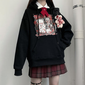 Black Menhera bear graphic hoodie worn with a hand in the front pouch pocket.