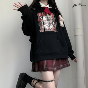 Black Menhera bear graphic hoodie shown in a wider outfit with one hand raised.