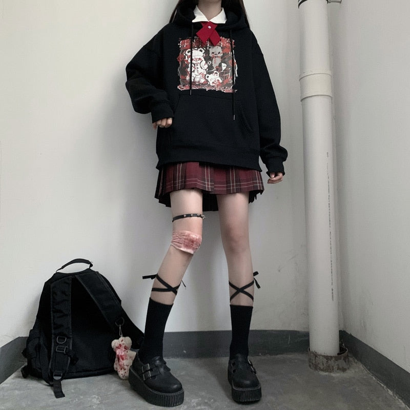Black Menhera bear graphic hoodie shown in a full outfit with separate skirt, bag and footwear.