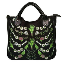 Front photograph of the black Monster Mash handbag with green hands, eyeballs, bones and pink brains visible below the curved handles.
