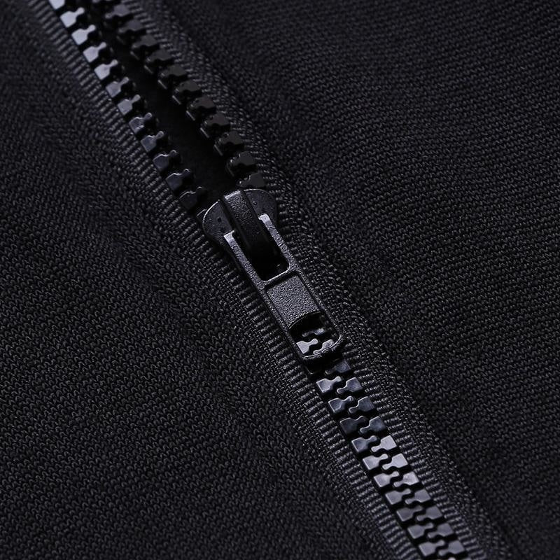 Close view of the black hoodie's front zipper beside the white crescent moon print.